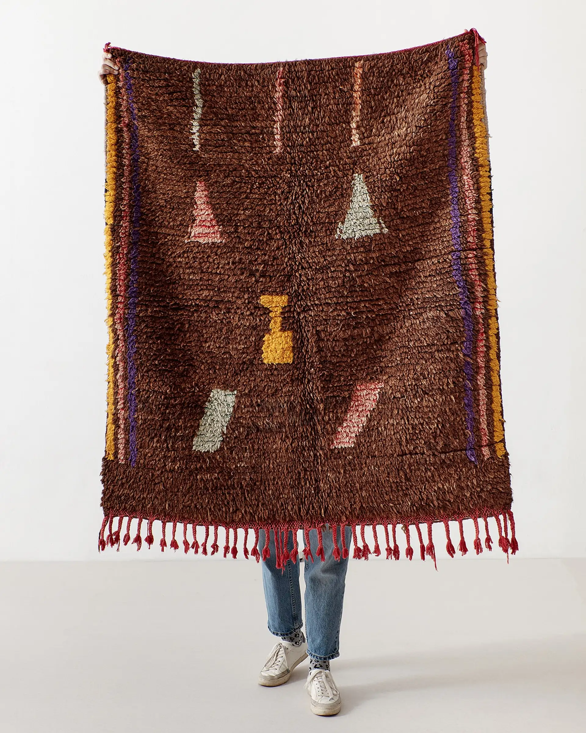 Brown rug with small pastel pictograms