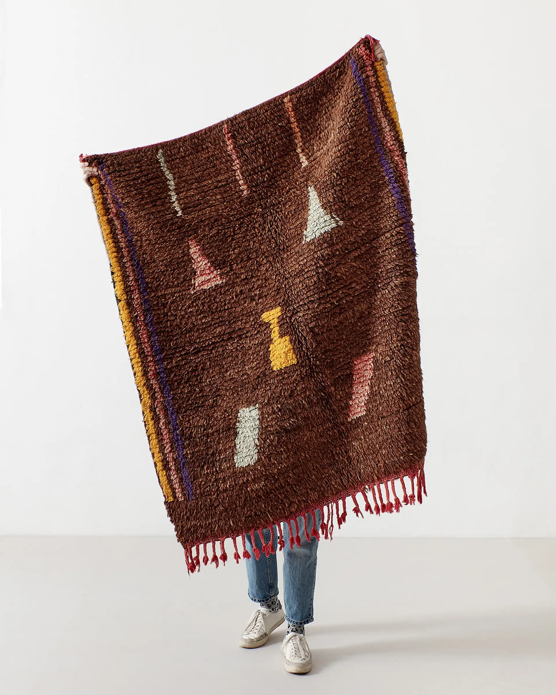 Brown rug with small pastel pictograms