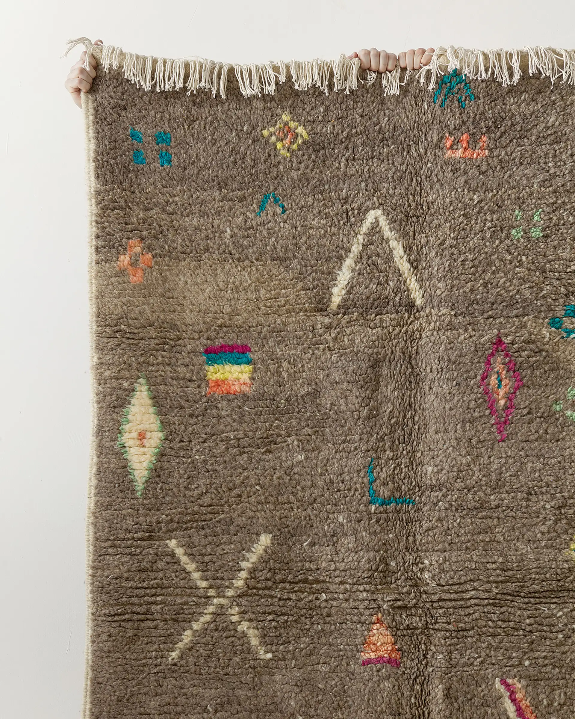 Grey rug w multicolour motifs, close-up