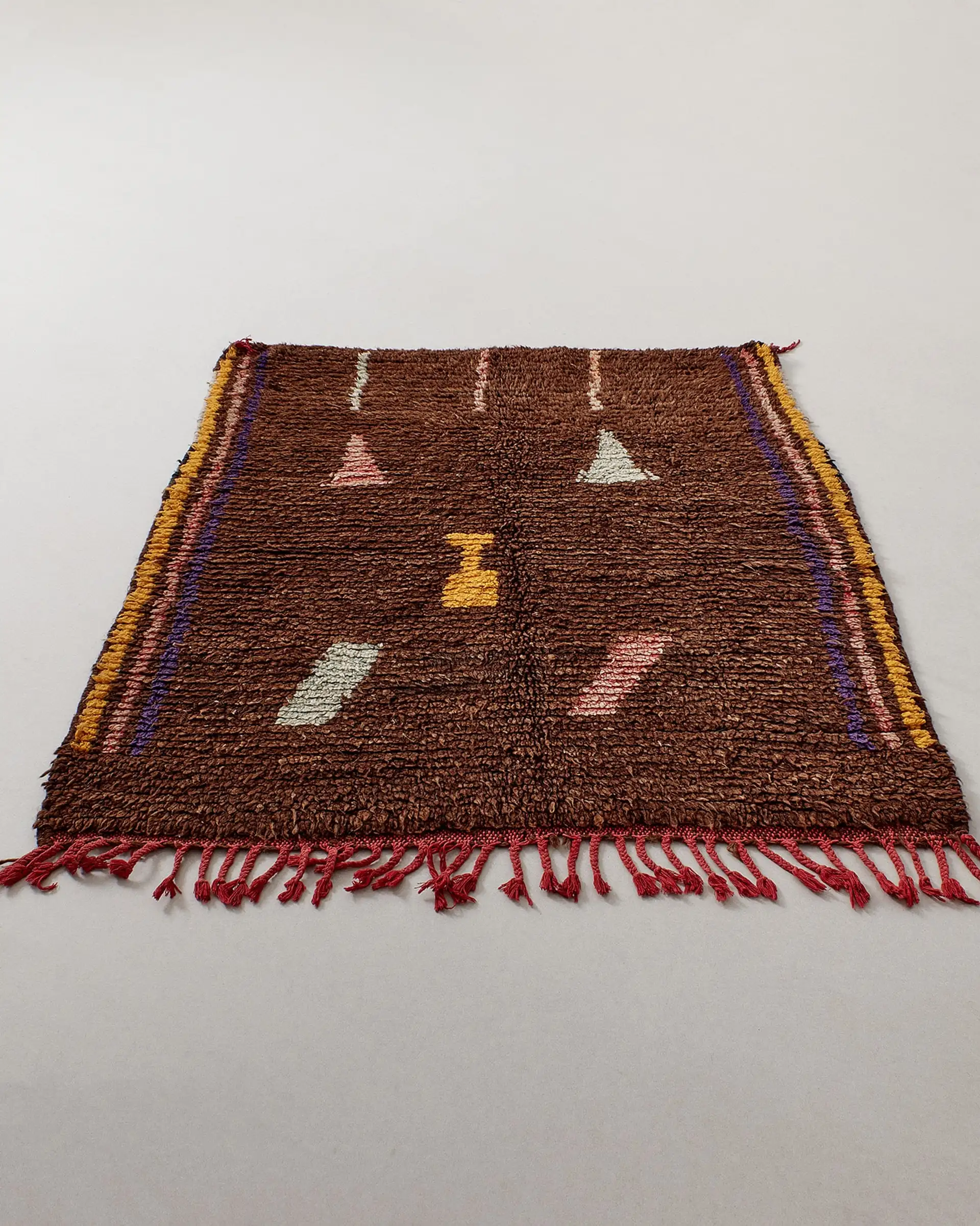 Brown rug with small pastel pictograms