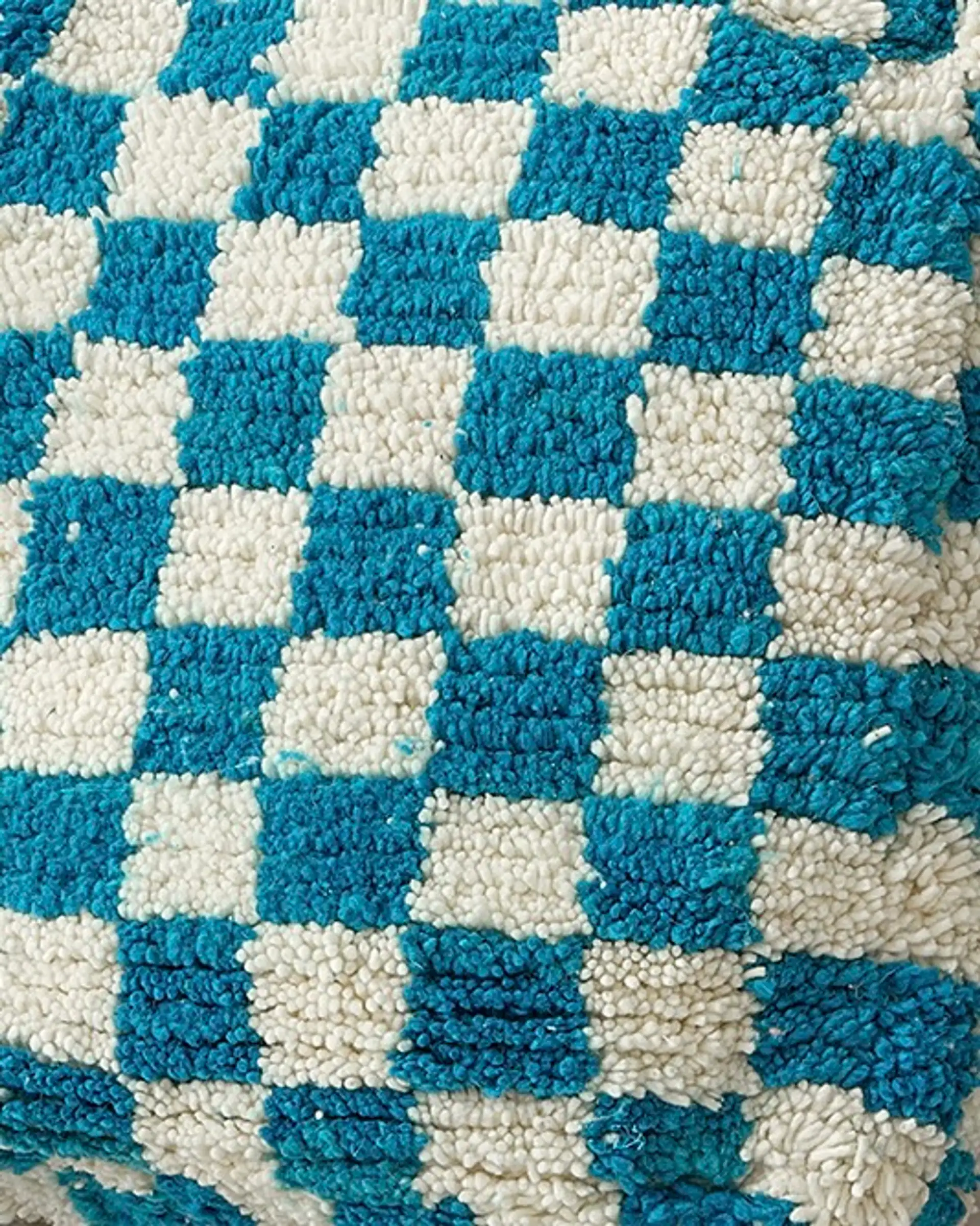 Turquoise checkered pouf close-up